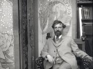 Alphonse Mucha, detail of Self-portrait with posters for Sarah Bernhardt at the studio in rue du Val-de-Grâce, Paris, circa 1901. Modern print from original glass plate negative. 9 7/16 × 7 1/16 in.