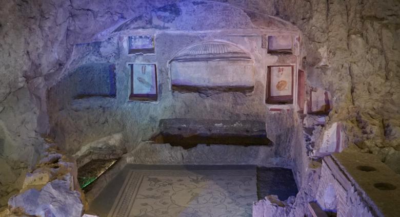 The large family tomb, cut into the rock of the hillside, with painted frescos and mosaic paving.