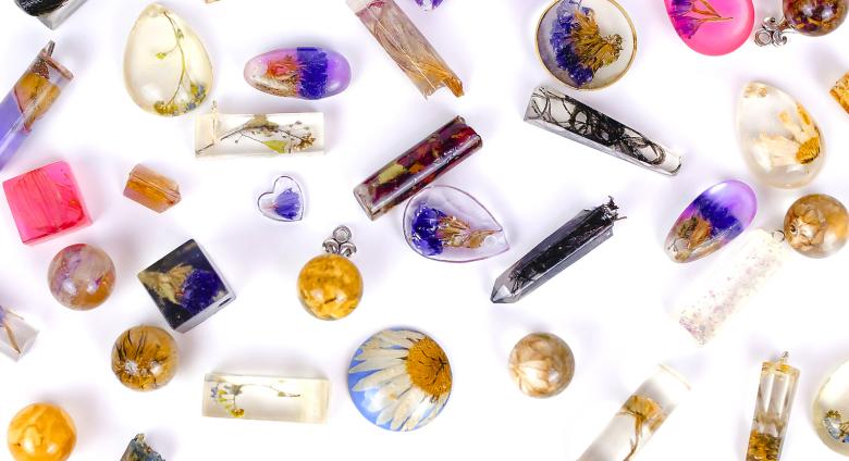 Various resin charms of different shapes and colors on a white background.