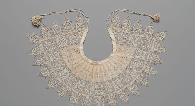 Detailed and petite lace collar. Unknown, 1610-1620, Standing Band (Collar) with Tassels, Cutwork, needle lace, reticello, punto in aria, embroidery, linen. Gift of Mrs. Edward S. Harkness, 1930. The Metropolitan Museum of Art. .