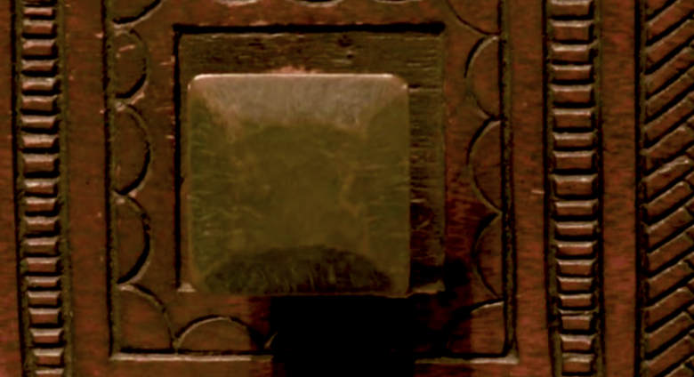 Detail of carved chest, showing two knobs