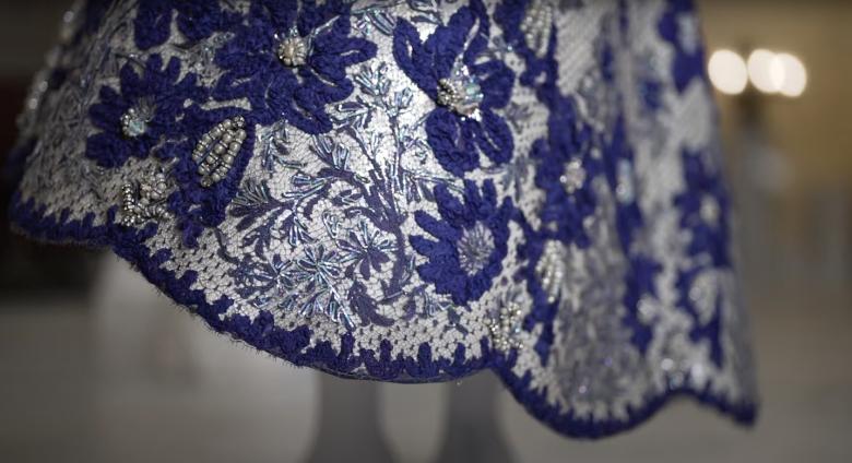 Still #2 from Met Preview Video of the exhibition, In America- An Anthology of Fashion. Features a blue, bejeweled dress hem