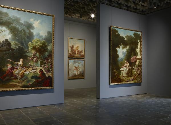 Four grand panels of Fragonard’s series The Progress of Love are shown together at Frick Madison in a gallery illuminated by one of Marcel Breuer’s trapezoidal windows. This view shows two of the 1771–72 paintings, with two later overdoors visible in the next gallery.