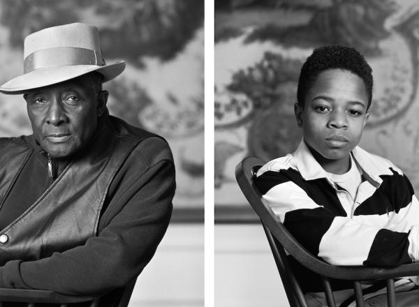 Black and white photo of seated Fred Stewart II and Tyler Collins. Both look at camera.