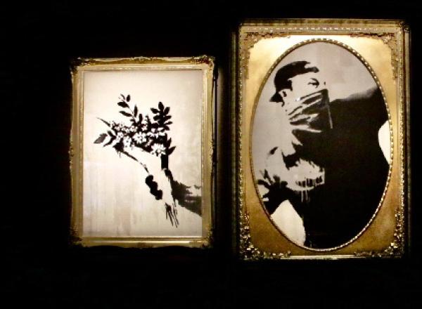 Installation view of Banksy: Genius or Vandal? in Los Angeles, 2021-2022 featuring "love is in the air" sectioned into frames.