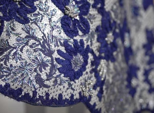 Still #2 from Met Preview Video of the exhibition, In America- An Anthology of Fashion. Features a blue, bejeweled dress hem